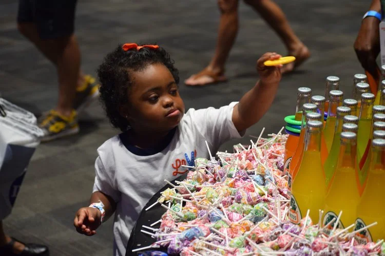 A child playing a ring-toss game at a past fair
